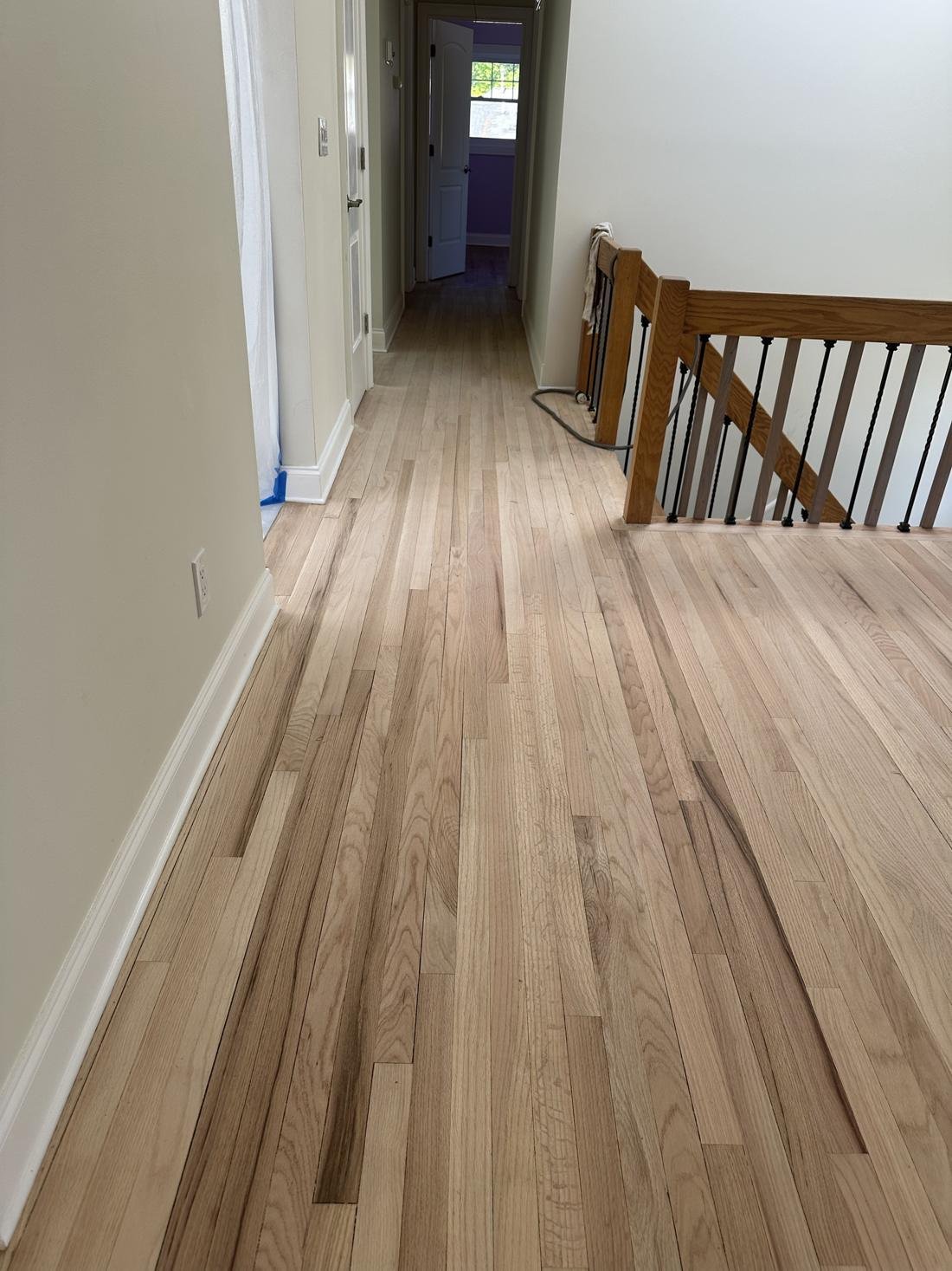 Upstairs hallway and stair landing sanded to raw oak